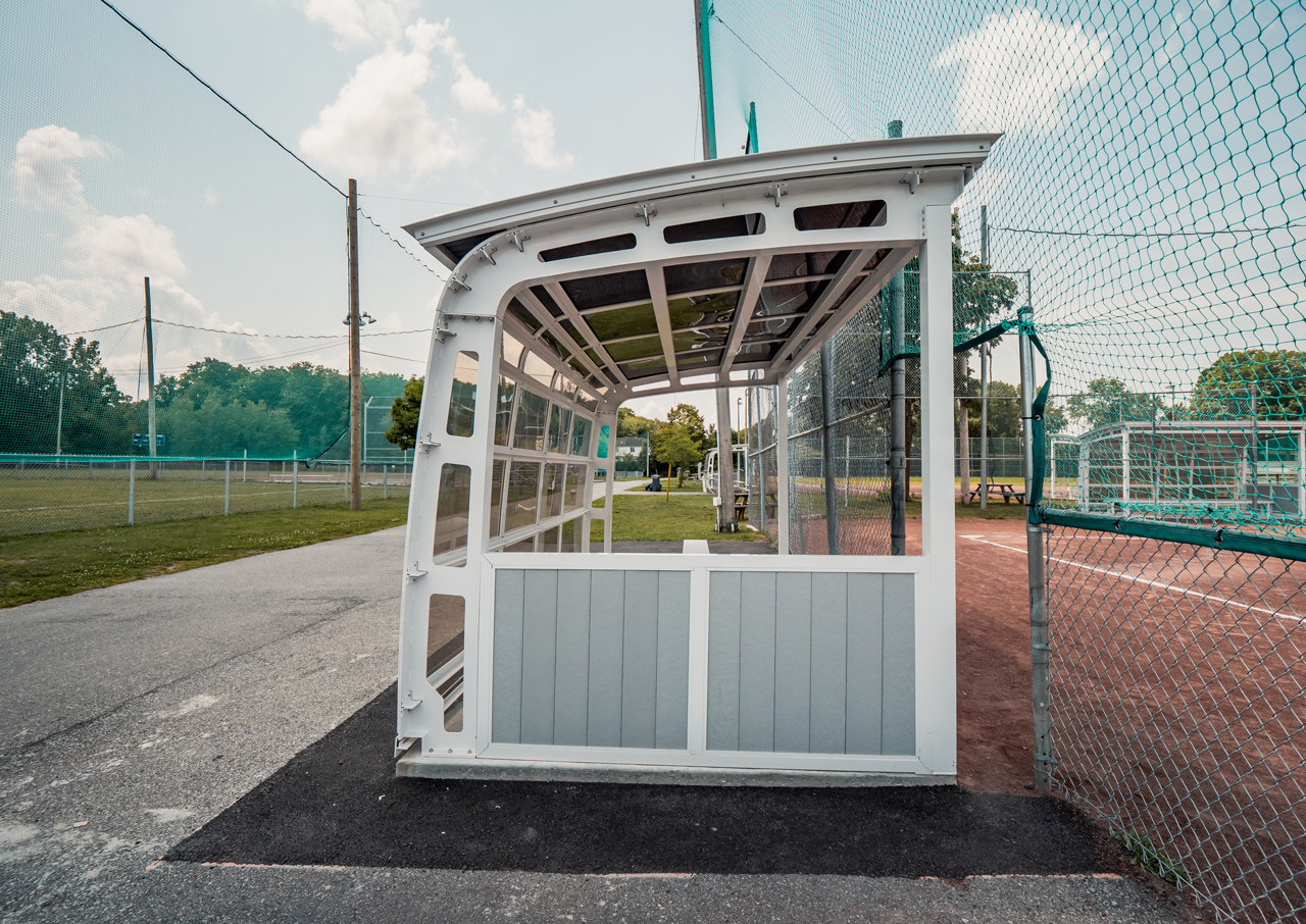 Side view of a semi-enclosed baseball field dugout