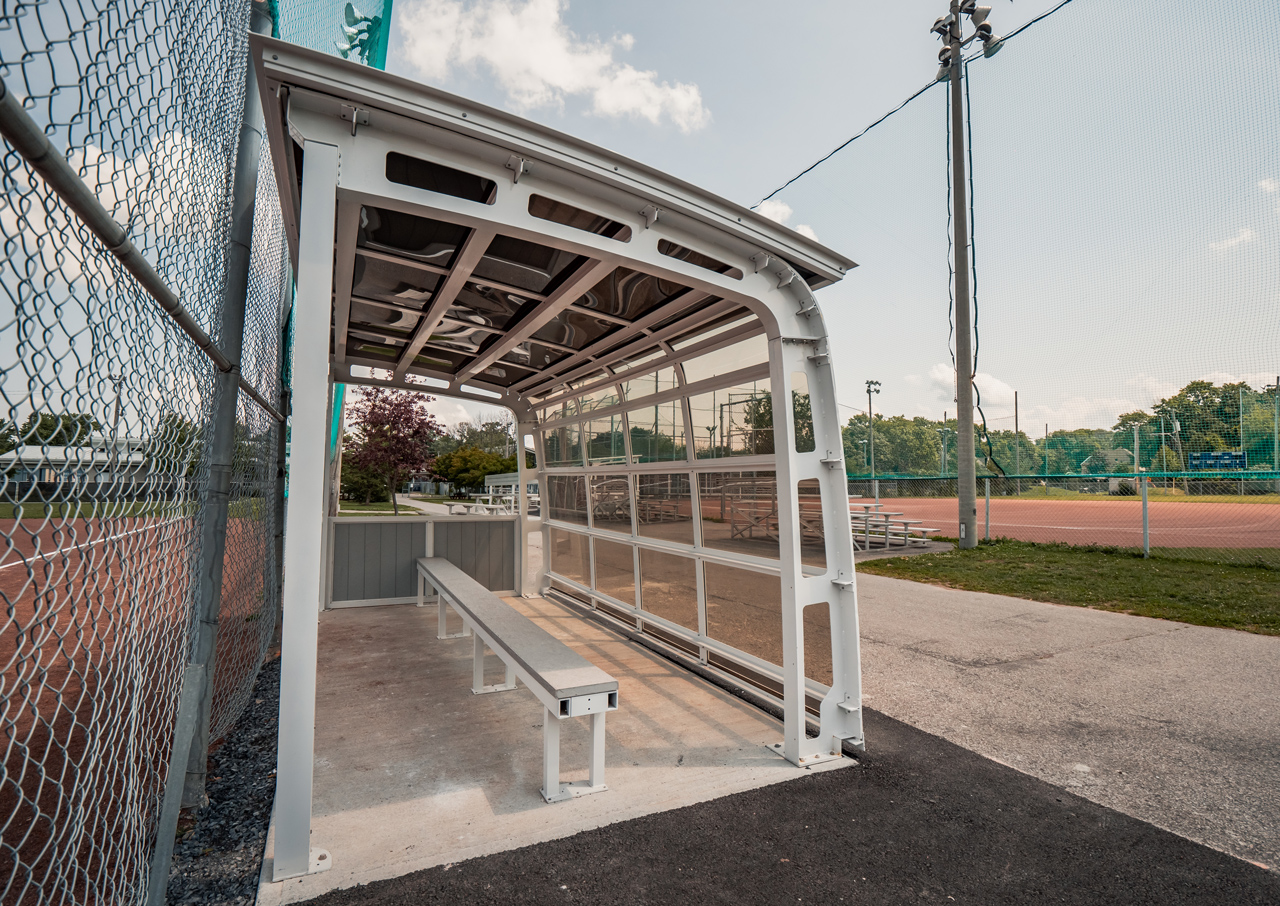 View of a semi-enclosed park shelter on a baseball field